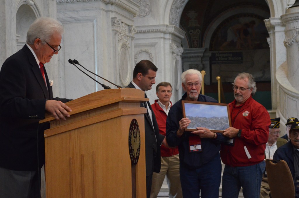 Ken Miller after receiving a framed reproduction of "Saipan Bonsai Charge" by John Hamilton.