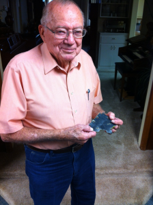 94-year-old Bob Bower holding a piece of the wing of his F6F Hellcat.