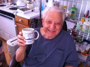Harold "Hal" Loew with a mug depicting his WWII battleship, the USS Colorado.