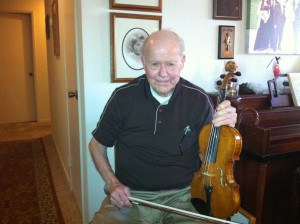 Leon with one of the violins he made.