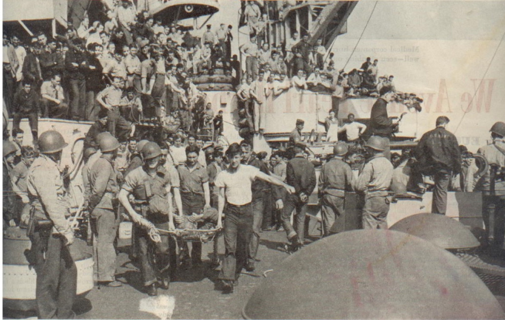 This photo from the Saturday Evening Post shows Leon (left) carrying a wounded soldier.