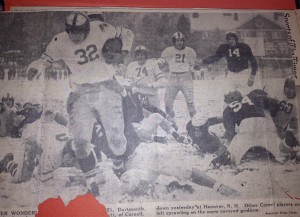 Carrying the ball with his four-fingered left hand, Dartmouth tailback Francis O'Brien rumbles through the snow and the Cornell defense.