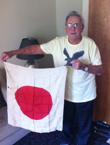 88-year-old George Christman with the Japanese flag he captured on Okinawa on April 1, 1945.