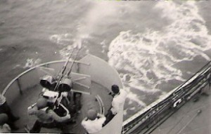 Charlie firing one of the Brookings' guns in an effort to explode Japanese mines.