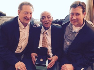 Monte Irvin receiving a World Series ring in 2015 from San Francisco Giants' President/CEO Larry Baer (left) and General Manager Bobby Evans (right)