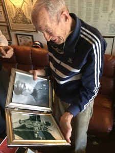 Dick Over looking at photographs of his father, a U.S. Marine Corps veteran of World War I.