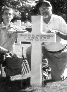 Lt. Ken Underwood's son and grandson at his grave in Mattingly, England.